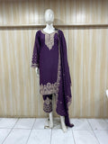 Purple embroidered dress on a mannequin against a striped