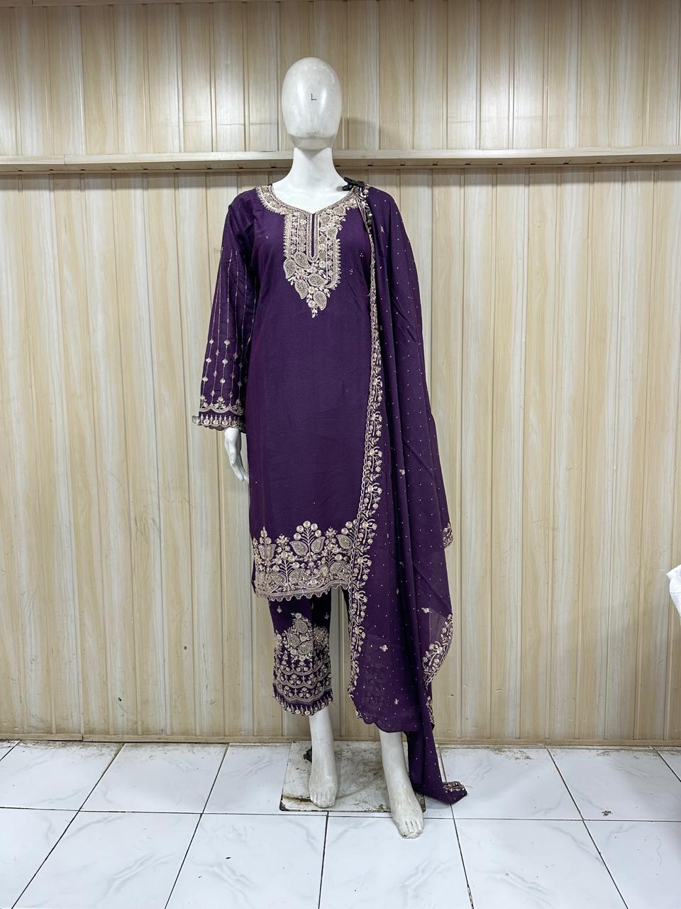 Purple embroidered dress on a mannequin against a striped