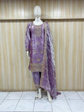 Purple embroidered dress on a mannequin against a wooden panel background