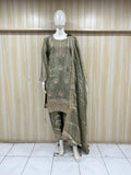 Mannequin wearing a traditional olive green outfit with embroidery against a striped