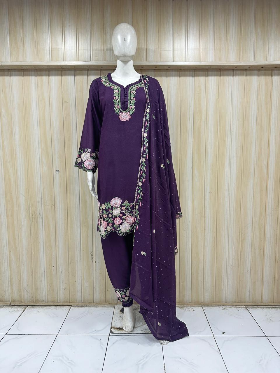 Purple embroidered outfit on a mannequin against a striped