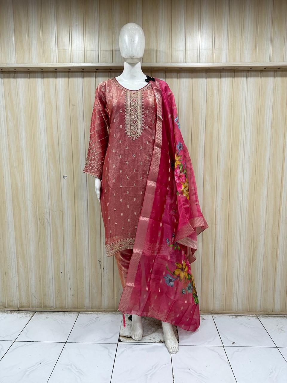 Mannequin wearing a traditional outfit with a pink embroidered dress and dupatta against a striped  ChatGPT7:16 PM