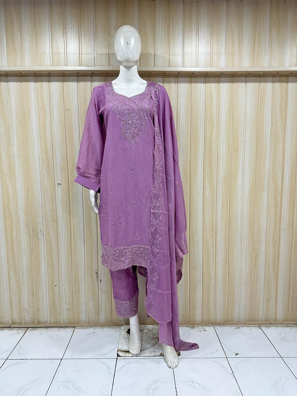 Purple embroidered outfit on a mannequin against a striped