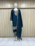 Mannequin wearing a dark blue embroidered outfit against a striped