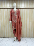 Red traditional outfit with embroidery on a mannequin against a striped