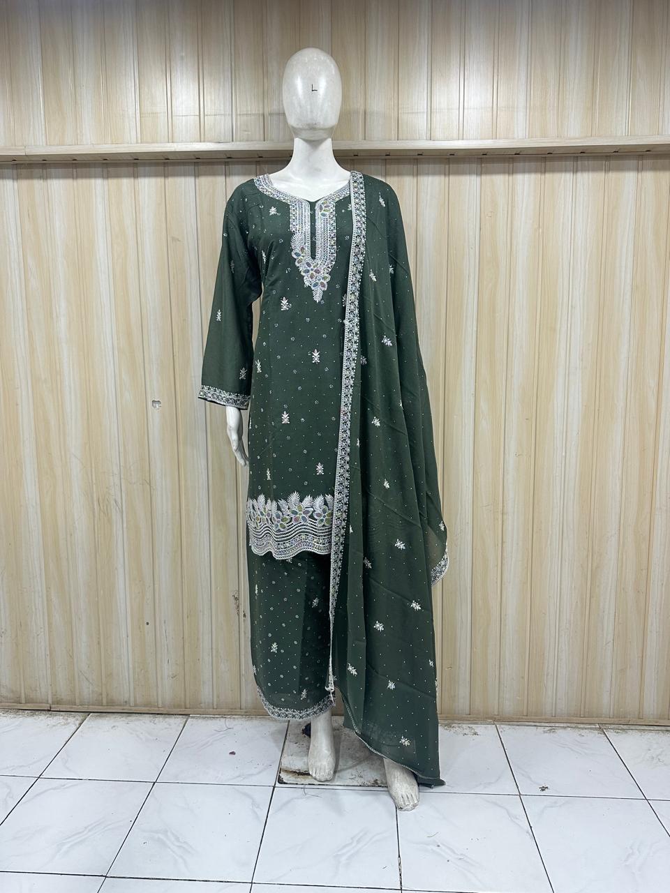 Green traditional outfit with white embroidery on a mannequin against a striped