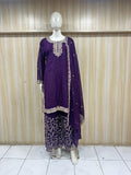 Purple embroidered outfit on a mannequin against a wooden panel background