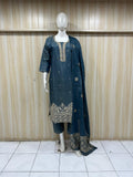 Mannequin wearing a blue embroidered outfit with a matching dupatta against a striped