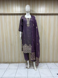 Mannequin wearing a purple traditional outfit with embroidery against a striped
