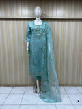 Teal embroidered outfit with a dupatta on a mannequin against a striped