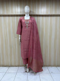 Mannequin wearing a maroon traditional outfit with embroidery against a striped