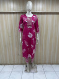 Mannequin wearing a pink colored outfit against a striped