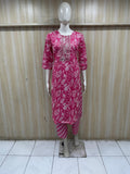 Mannequin wearing a dark pink colored outfit against a striped