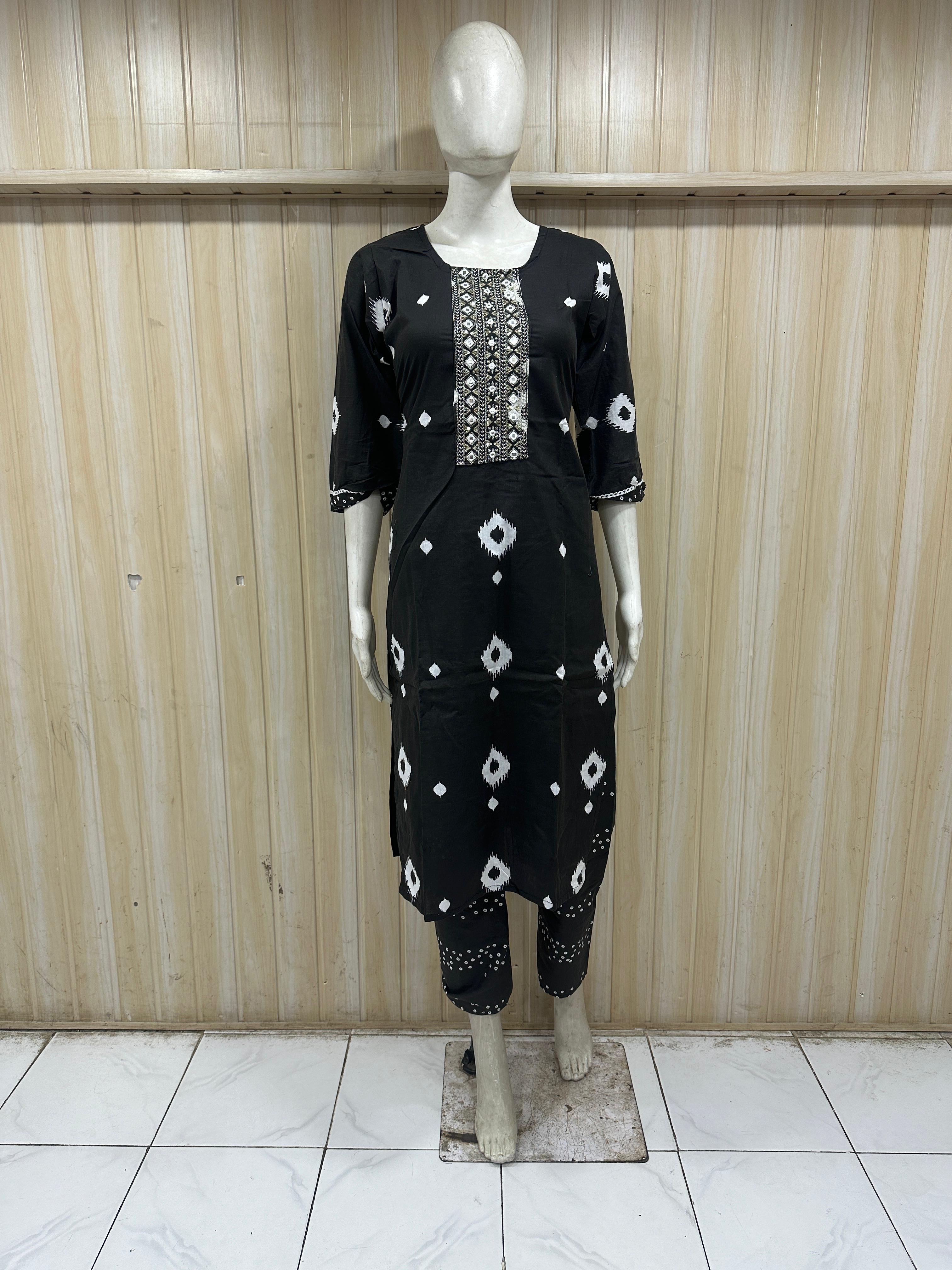 Black outfit with white patterns on a mannequin against a striped