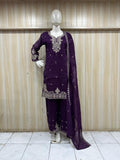 Purple embroidered traditional outfit on a mannequin against a striped