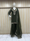 green embroidered dress with sheer dupatta on a mannequin against a striped