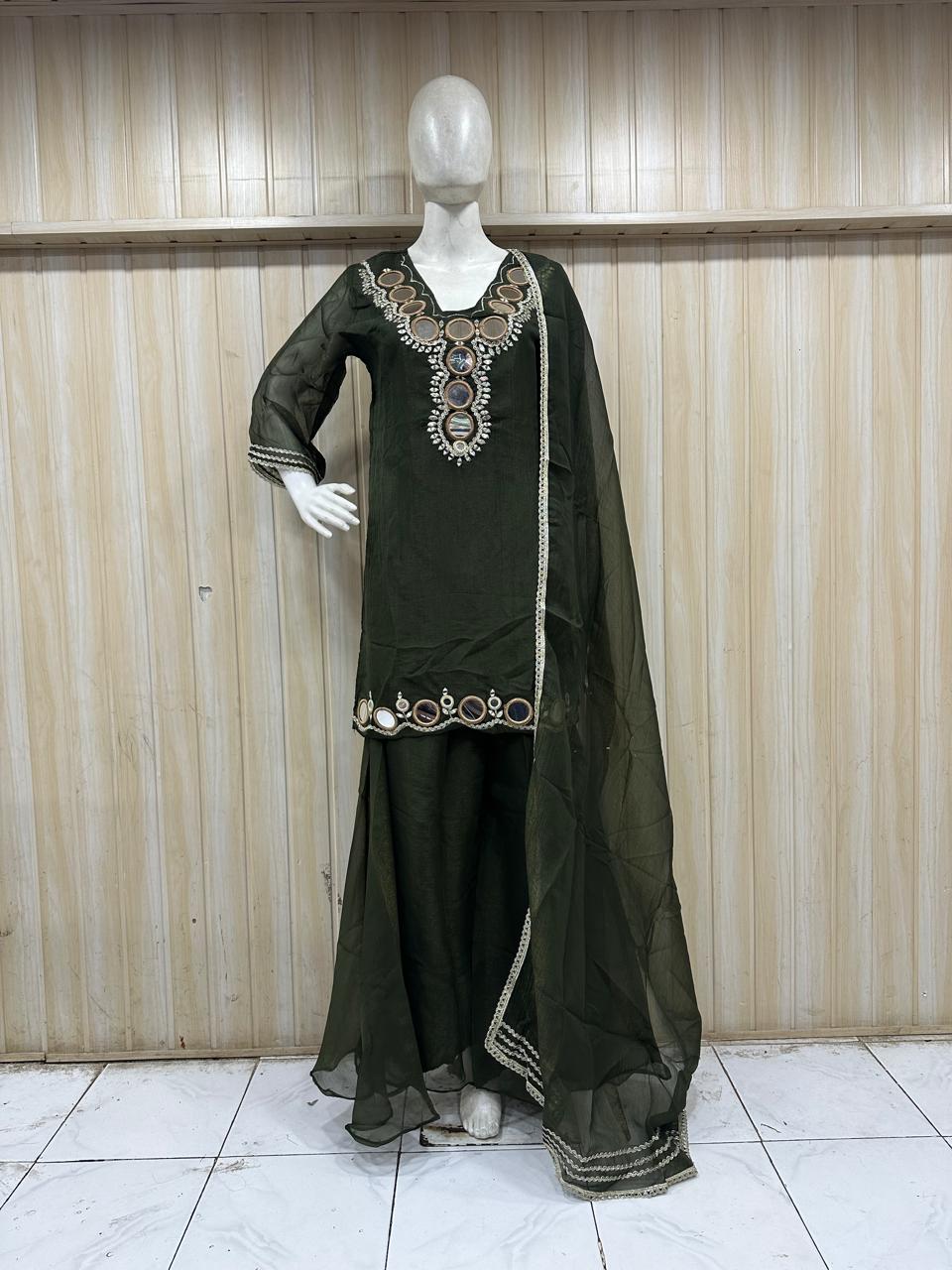 green embroidered dress with sheer dupatta on a mannequin against a striped