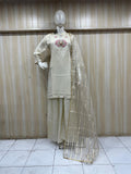 Mannequin wearing a cream-colored traditional outfit with a floral design against a wooden panel background.