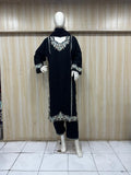 Black traditional outfit with white embroidery on a mannequin against a striped