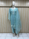 sky blue traditional outfit with white embroidery on a mannequin against a striped
