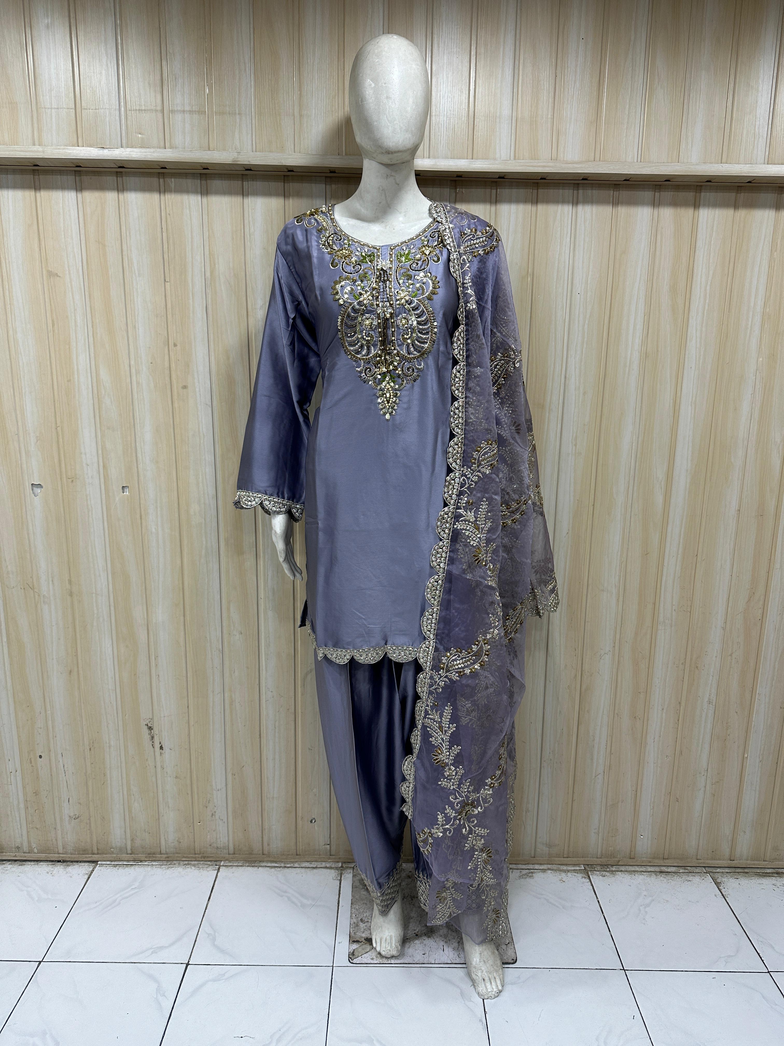 Mannequin wearing a purple fharshi outfit against a striped