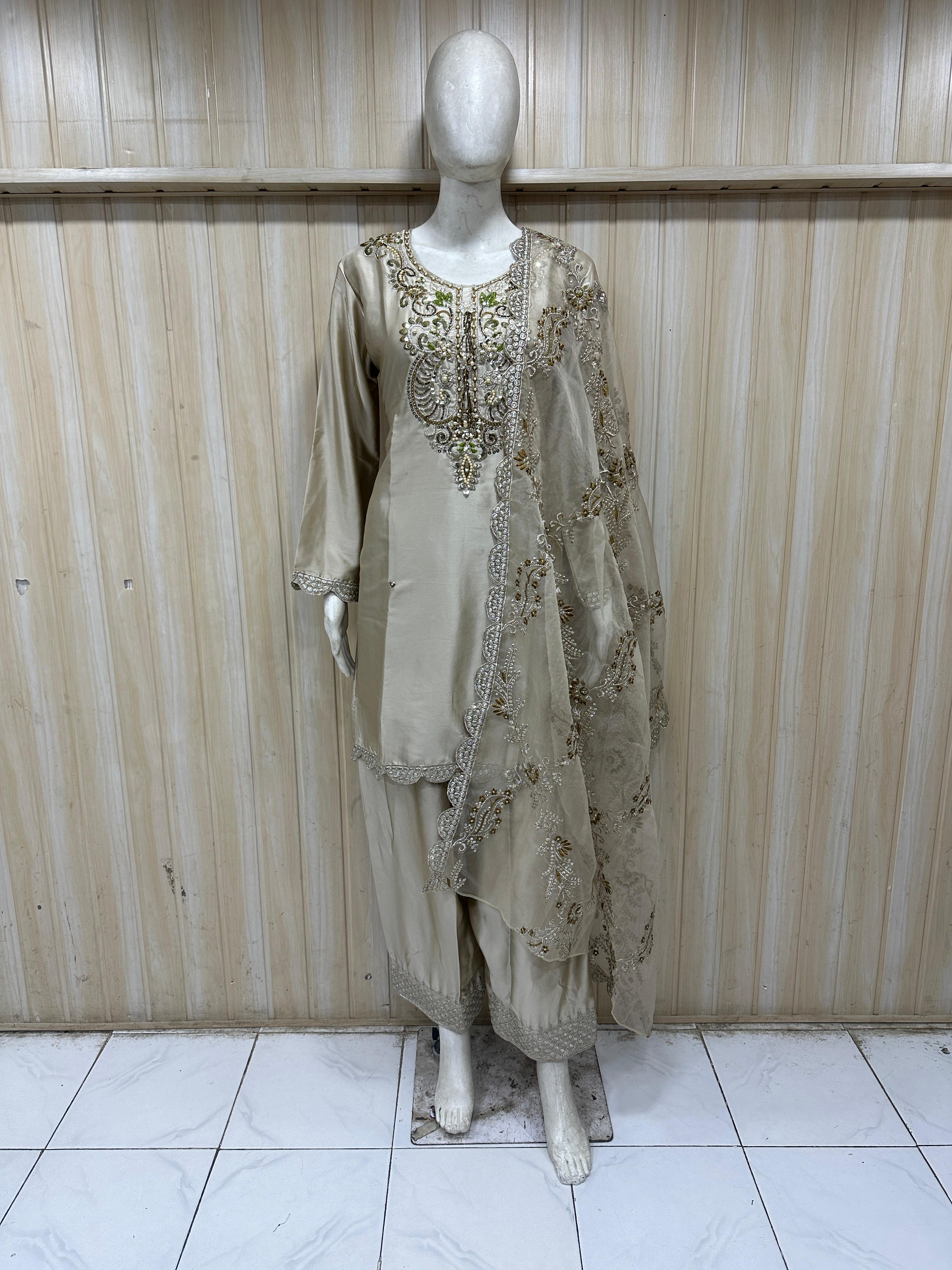 Mannequin wearing a beige farshi outfit against a striped