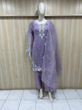Purple embroidered outfit on a mannequin against a striped