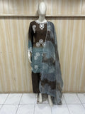 grey brown embroidered outfit on a mannequin against a striped