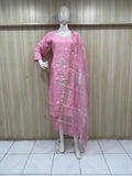 pink and white embroidered outfit on a mannequin against a striped