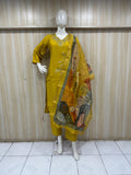 Mannequin wearing a green traditional outfit with embroidery against a striped