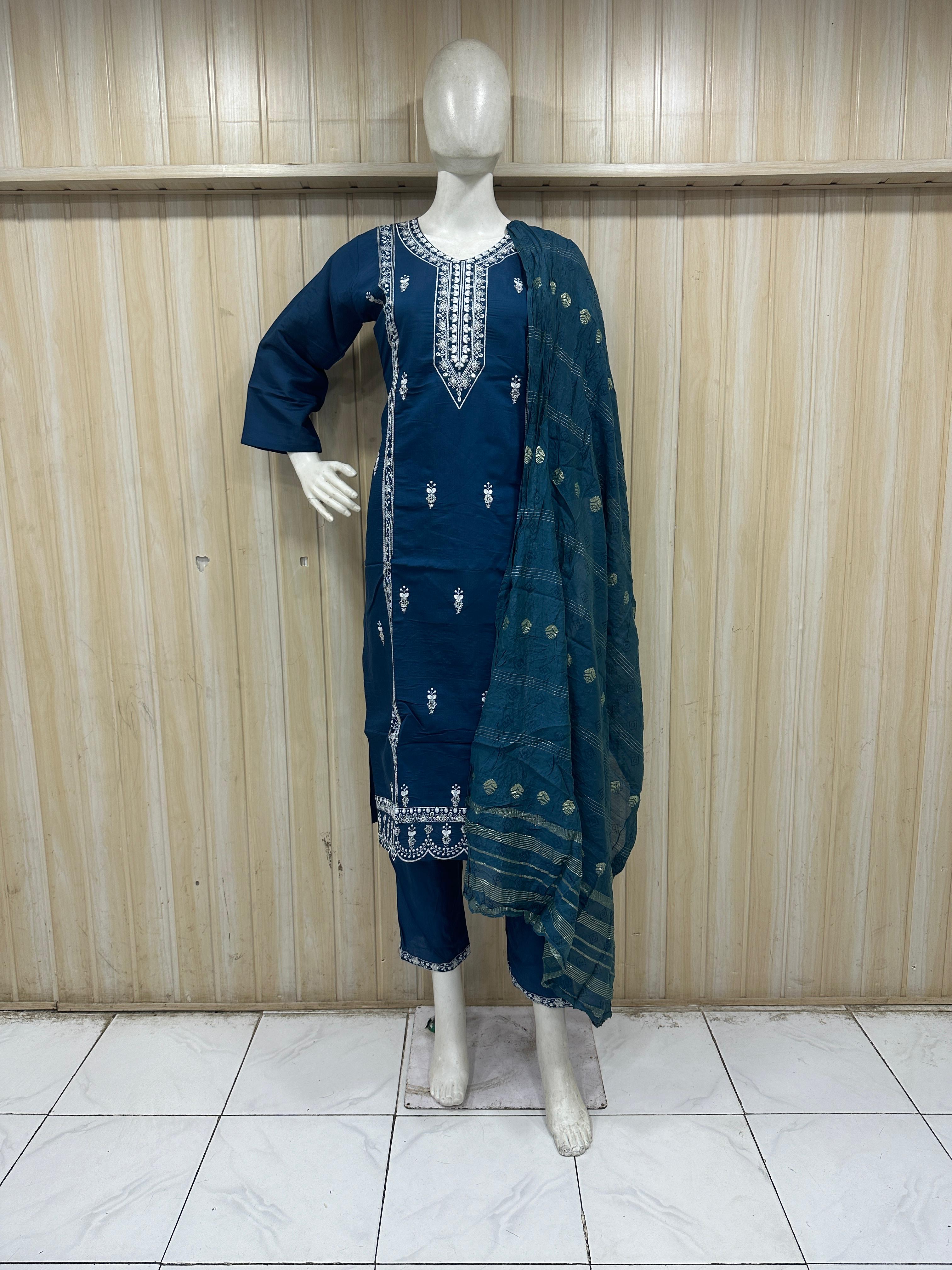 Mannequin wearing a navy blue traditional outfit with embroidery against a striped