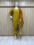 Mannequin wearing a green embroidered outfit with a matching dupatta against a striped