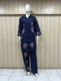 Navy blue outfit with patterns on a mannequin against a striped