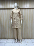 Mannequin wearing a beige outfit with floral embroidery against a striped
