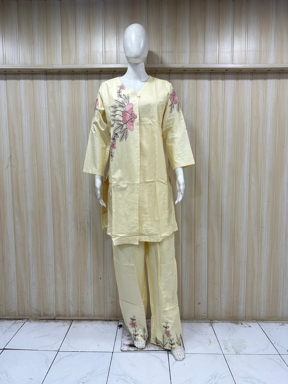 Mannequin wearing a light yellow outfit with floral patterns against a striped