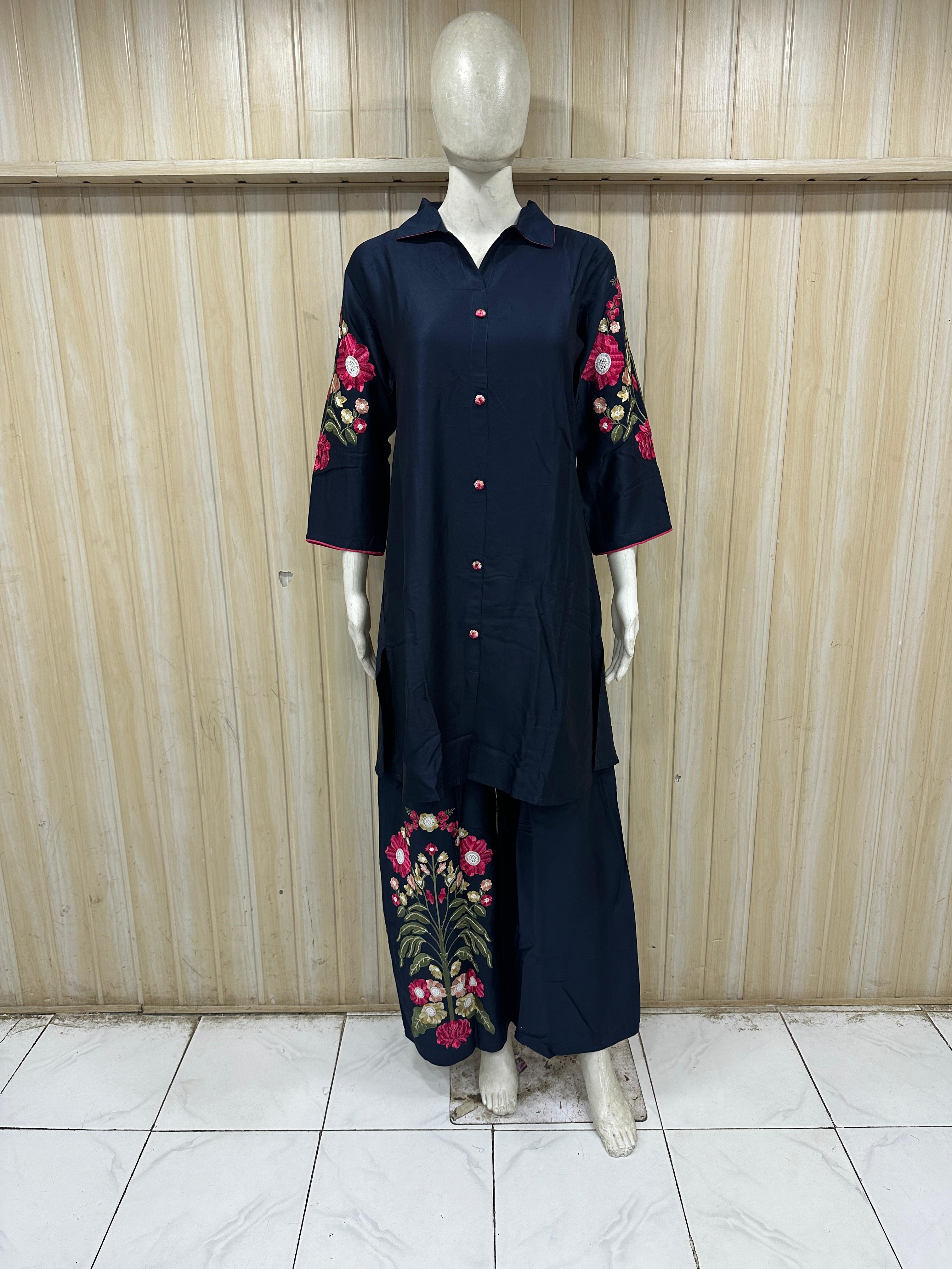 Mannequin wearing a navy blue dress with geometric patterns against a striped