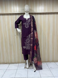 Mannequin wearing a purple dress with floral patterns against a striped