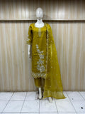 Mannequin wearing a yellow traditional outfit with floral patterns against a striped