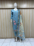 Mannequin wearing a blue floral dress with a matching dupatta against a striped