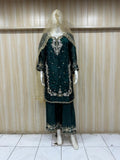 Traditional outfit with embroidered design on a mannequin against a striped