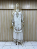 White embroidered traditional outfit on a mannequin against a striped