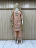 Traditional outfit with embroidered pink dress and dupatta on a mannequin against a striped