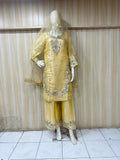 Mannequin wearing a yellow embroidered traditional outfit against a striped
