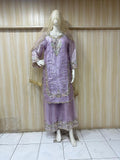 Mannequin wearing a lavender embroidered outfit against a striped