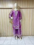 Purple embroidered traditional outfit on a mannequin against a striped