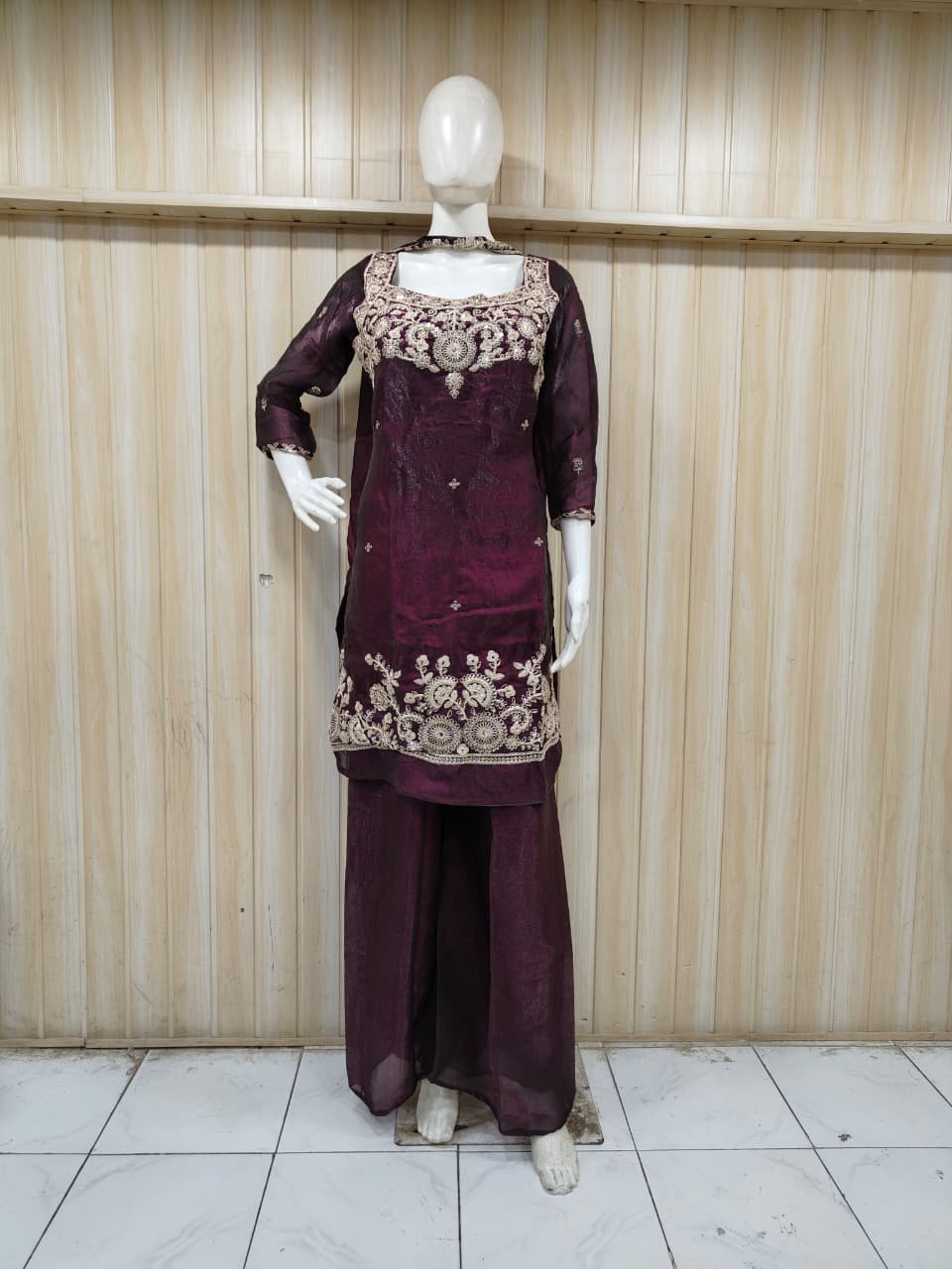 dark Purple embroidered outfit on a mannequin against a striped