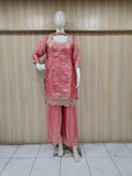 pink embroidered outfit on mannequin against striped