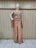 beige embroidered outfit on mannequin against striped