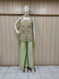 green embroidered outfit on mannequin against striped