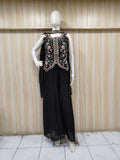 black embroidered outfit on mannequin against striped